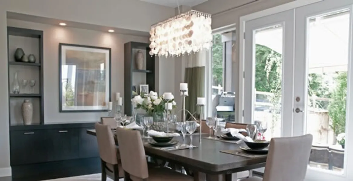 Elegant dining room chandelier installation above table in Chicago, IL
